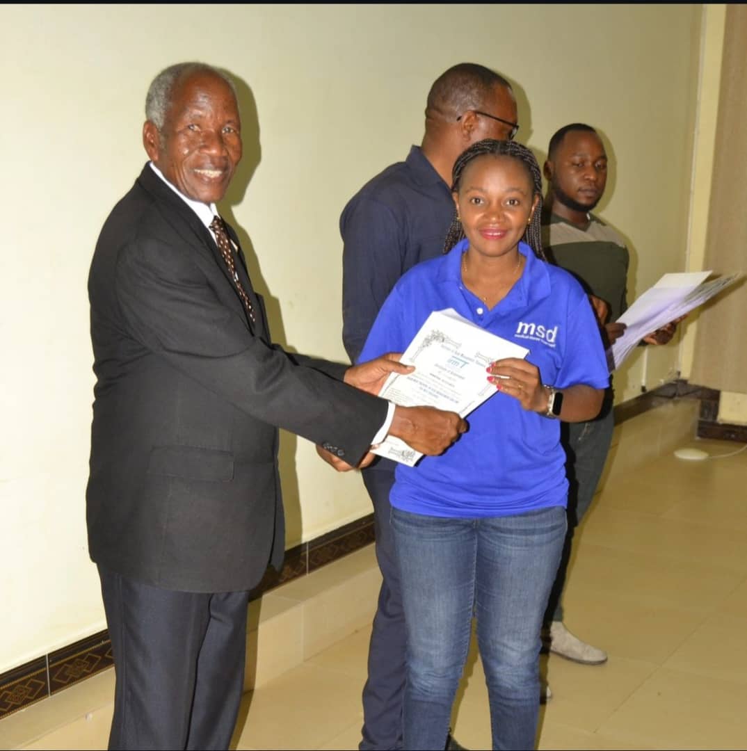 One of the Participants from MSD Receiving a Certificate After Completing the Training
