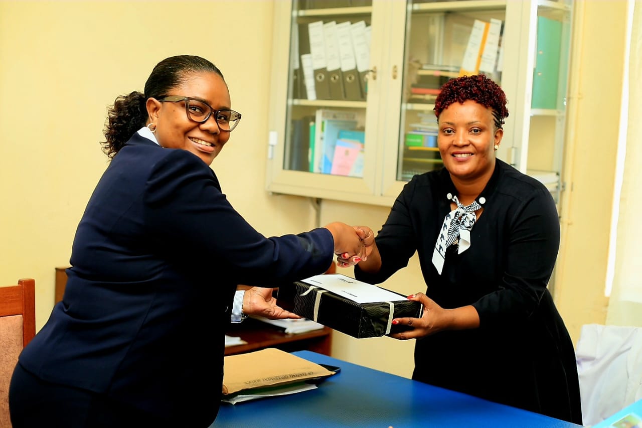 Chairperson of the MSD Board of Trustees, Mrs. Rosemary Silaa, Presenting a Gift to the Acting Chief Medical Officer of the Bukoba Regional Referral Hospital, During Her Visit to the Hospital