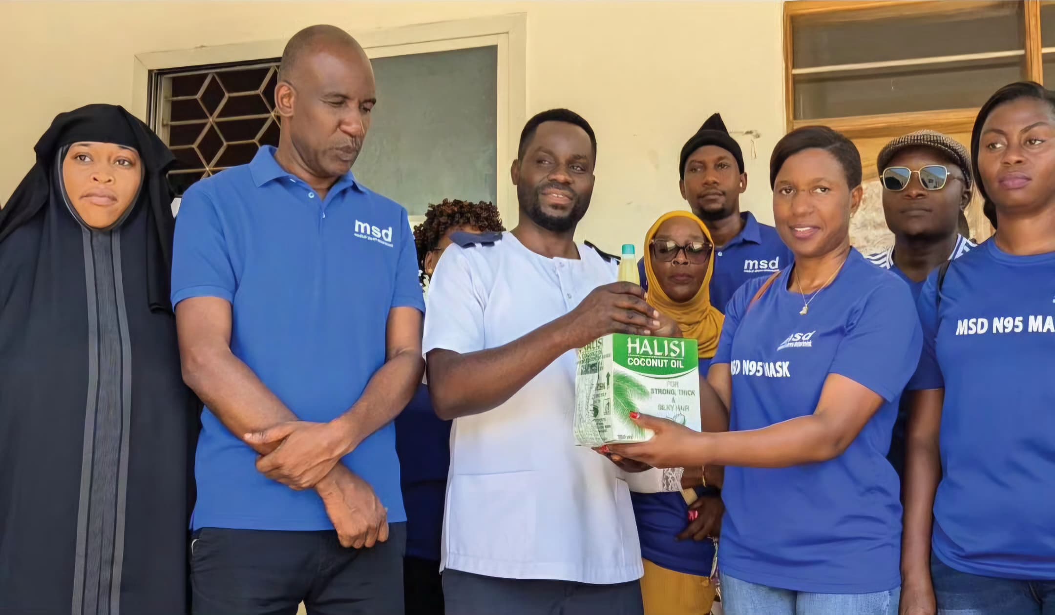 MSD Sports Secretary Ms. Gloria Lisawa Presenting Assistance to the Ngamiani Health Center, on behalf of MSD Sportsmen