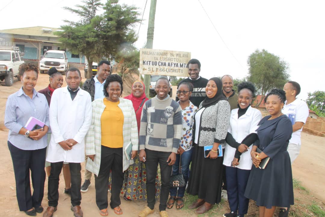 MSD Board of Trustees Member Dr. Mwifunyi Posing for a Photo with MSD Customers in Lushoto District