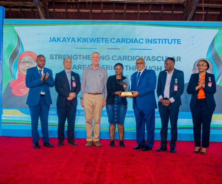 MSD Customer Service Officer Dar es Salaam Region Ms. Diana Kimario Receiving an Award from the Official Guest and Minister of Health of the Revolutionary Government of Zanzibar on behalf of MSD Leadership, During the International Heart Disease Conference