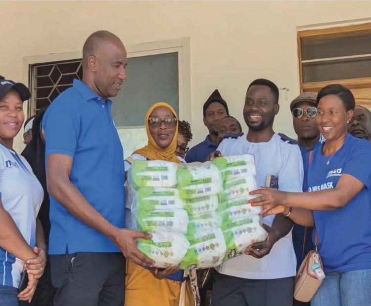 Tanga Regional Manager Representative Mr. Grant Mwapele Presenting Assistance to the Leaders of the Ngamiani Health Center on behalf of the MSD Leadership