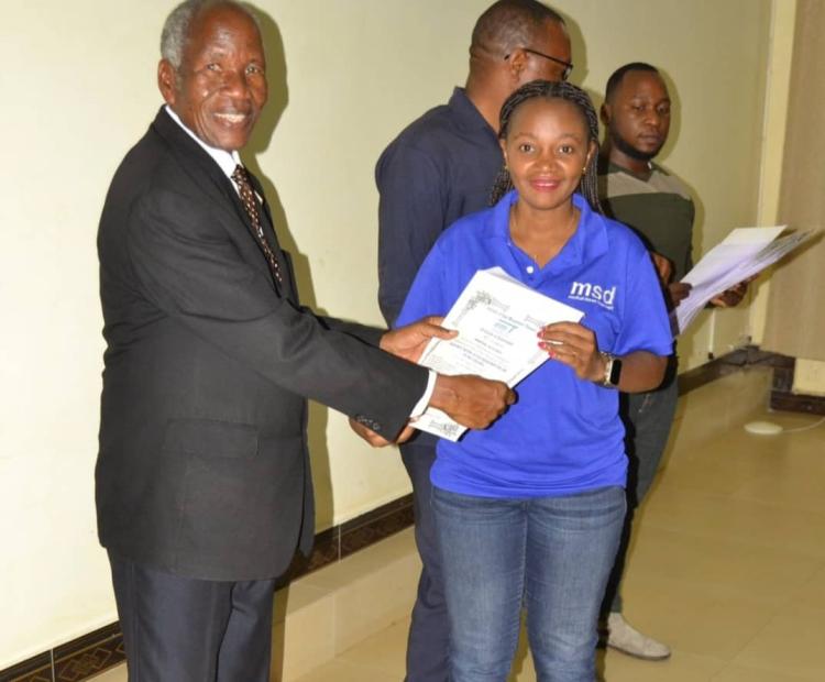 One of the Participants from MSD Receiving a Certificate After Completing the Training